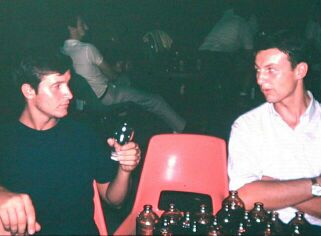 David White on left; on right Peter, chef of the executive management canteen and formidable tennis player